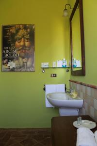 a bathroom with a sink and a movie poster on the wall at L'Atelier di Pierflavio Gallina in La Morra