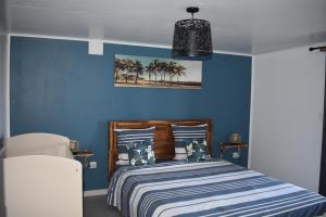 una camera da letto blu con un letto con pareti blu di Au Coeur des hauts Cilaos a Cilaos