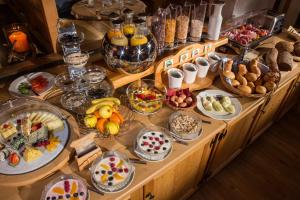 a buffet with many plates of food on a table at Hotel Cheminee in Zermatt