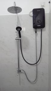 a shower with a camera on the wall at Lake Edge Resort in Anuradhapura