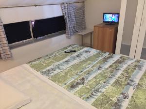a bedroom with a bed and a television in it at Camere Da Aldo in centro Sirolo in Sirolo
