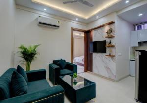 a living room with a couch and a table at The Grand Hotel Akshay in Gurgaon