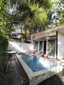 a small swimming pool in front of a house at The State Resort in Ban Wat Phrik