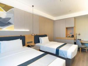 a hotel room with two beds and a kitchen at Home Inn Kunming Baita Road in Kunming +150 photos