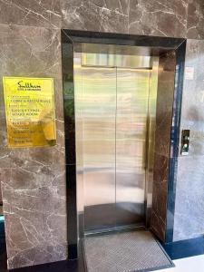 a elevator in a building with a sign on it at Sulthan Hotel & Restaurant in Cochin +13 photos