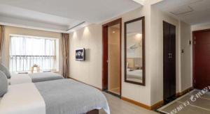 Postel nebo postele na pokoji v ubytování Oriental Hotel