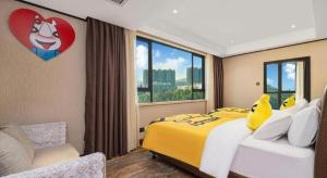 a bedroom with a large yellow bed with a large window at HELSTON HOTEL in Huadu +217 photos