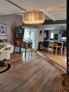 a living room with a ping pong table and a kitchen at La Villa du Teich in Le Teich +25 photos