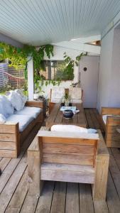 a room with two beds and a table on a deck at La Villa du Teich in Le Teich