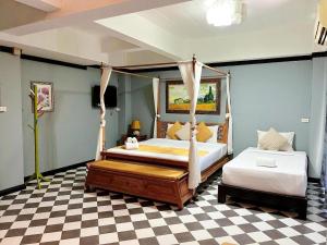 a bedroom with two beds and a checkered floor at Ladawan Boutique Hotel in Ban Pak Khlong