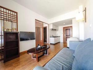 a living room with a couch and a table at Sky City Hotel in Ban Phôn Khéng