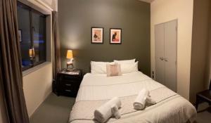 a bedroom with a large bed with towels on it at Cardrona Sanctuary in Cardrona +11 photos