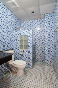 a blue tiled bathroom with a toilet and a sink at OYO 384 Ban Sabaidee in Phra Nakhon Si Ayutthaya