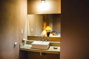 a bathroom with a sink in front of a mirror at Kallpa in Cafayate +47 photos