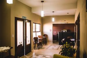 a living room with a table and chairs at Kallpa in Cafayate