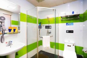 a green and white bathroom with a sink and a shower at 7 Days Inn Xi'an Railway Station in Xi'an +194 photos