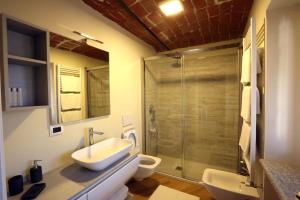 Un baño con lavabo, inodoro y ducha. en Alba sui Tetti apartment, en Alba 9 fotos más