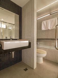 a bathroom with a sink and a toilet at OYO 225 Premier Place Bangkok in Bangkok