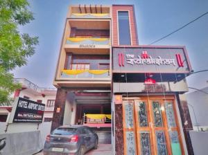 a building with a car parked in front of it at Hotel Airport Suites Suitable for Hourly Bookings in Lucknow