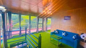 a room with a blue couch in a room with windows at nist wood in Lovedale