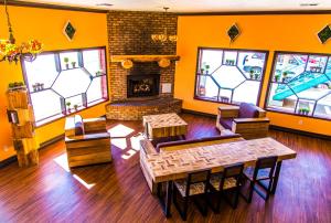 a living room with orange walls and a fireplace at Mountain View Lodge in Parowan