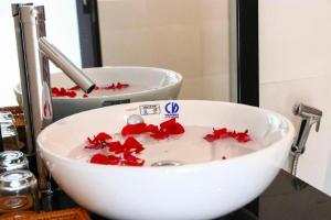 a bathroom sink with red decorations on it at Vientiane Chaleunxay Center Hotel in Vientiane +151 photos