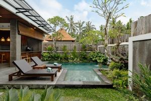 a swimming pool in the backyard of a house at Badawa Ubud Villa in Ubud