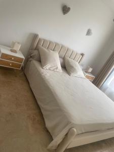 a bed with white sheets and pillows in a bedroom at Villa Le Luberon in Mérindol +27 photos