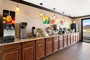 a large kitchen with a counter with a unintention at Quality Inn & Suites in Dumas