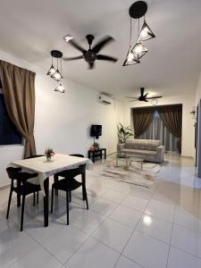 a living room with a table and a couch at Homestay501 in Kampong Jelatang