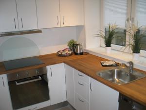 a kitchen with a sink and a wooden counter top at Aalborg City Rooms ApS in Aalborg