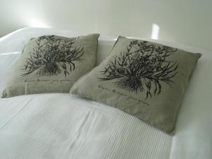a bed with two pillows on top of it at Aalborg City Rooms ApS in Aalborg