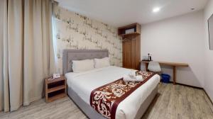 a hotel room with a bed and a window at Hotel LoLex Kuchai Lama in Kuala Lumpur +92 photos