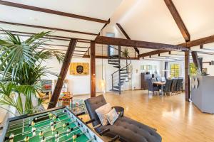 an open living room with a pool table at Ferienhaus Weitblick in Eslohe +37 photos
