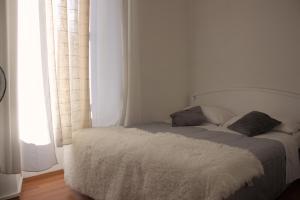 Posteľ alebo postele v izbe v ubytovaní Soggiorno Madrid