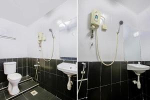 a bathroom with two sinks and a toilet and a mirror at OYO 822 Zande Motel Kuala Selangor in Kuala Selangor +102 photos