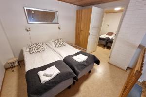 Postel nebo postele na pokoji v ubytování Kuukkeli Apartments Teerenpesue E 33