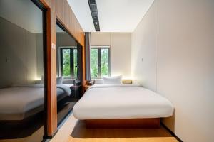 Giường trong phòng chung tại Xihe Hotel-Shanghai Lujiazui Lancun Road Subway Station Branch