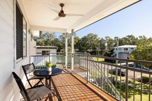 a patio with a table and chairs on a balcony at Smart Suites Self Check-in Apartments - Rocklea Station N in Brisbane