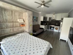 a small bedroom with a bed and a couch at Pi Sunyer Studio. in Roses