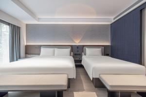 Letto o letti in una camera di Atour Light Hotel Beijing International Exhibition Center Liufang Subway Station