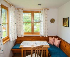 a dining room with a table and a window at Hütterhof in Grundlsee