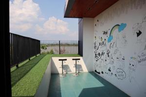a room with two chairs and a wall with graffiti at Chic-Chidkong Boutique Hotel in Nakhon Phanom