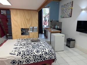 a bedroom with a black and white bed and a sink at Quintessential Brunswick retreat in Brunswick