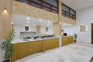 a restaurant with a counter in a building at Hotel Apex in Surat