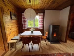 a dining room with a table and a fireplace at HIASN Haus in Bad Aussee +25 photos