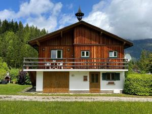 a large wooden house with a balcony at HIASN Haus in Bad Aussee