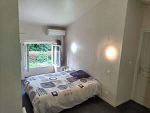 a small bedroom with a bed and a window at Appartement a louer à Cruas in Cruas