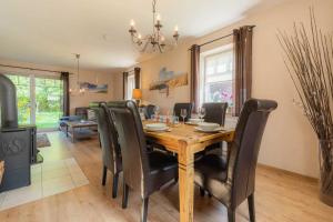 a dining room with a wooden table and chairs at Ferienhaus Ruh di ut ID 412 in Tönning