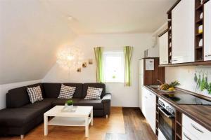 a living room with a couch and a table at Wohnung 5 ID 103 in Böhl